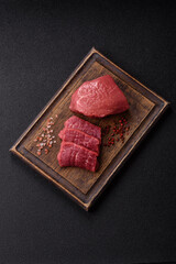 Raw beef tenderloin ribeye steak with salt and spices