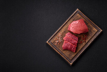 Raw beef tenderloin ribeye steak with salt and spices