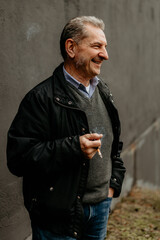 Elderly man enjoys a moment of reflection outdoors