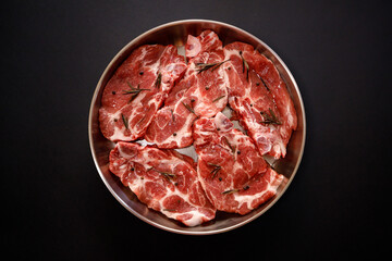 Freshly prepared pork chops ready for cooking