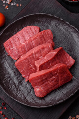 Raw beef tenderloin cut into slices with salt and spices
