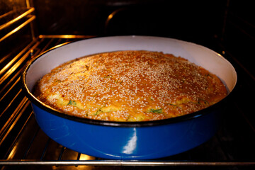 Savory cornbread baking in the oven with sesame seeds