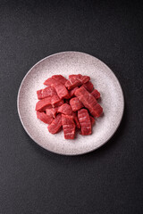 Raw beef tenderloin cut into slices with salt and spices