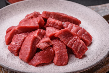 Raw beef tenderloin cut into slices with salt and spices