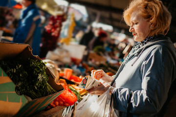 Senior Woman Shopping for Produce at an Outdoor Market	