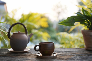 Old vintage Tea cup and earthenware teapot at the cozy garden, chilling outdoor relaxing