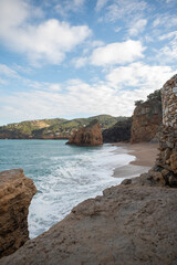 Waves crashing on a secluded beach in spain's costa brava