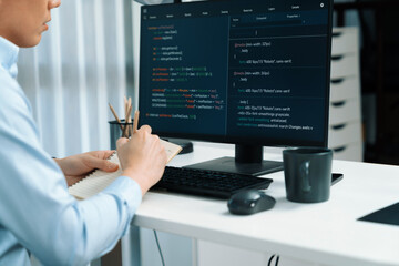 Smart IT developer looking at coding program application on computer screen of online website, analyzing intelligent database system development on business world market at modern office. Infobahn.