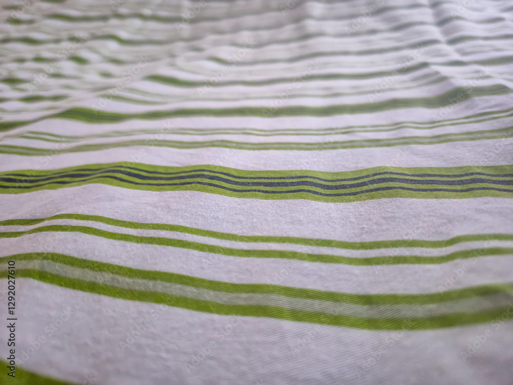 Poster a close-up of textured fabric with green and white stripes, creating a modern and fresh look suitabl