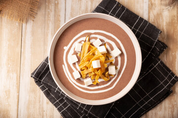 Creamy bean soup. In Mexico known as Crema de Frijoles, a very easy and nutritious homemade food recipe, commonly accompanied with cheese, cream, avocado and corn tortilla cut into strips and fried.