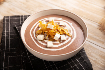 Creamy bean soup. In Mexico known as Crema de Frijoles, a very easy and nutritious homemade food recipe, commonly accompanied with cheese, cream, avocado and corn tortilla cut into strips and fried.