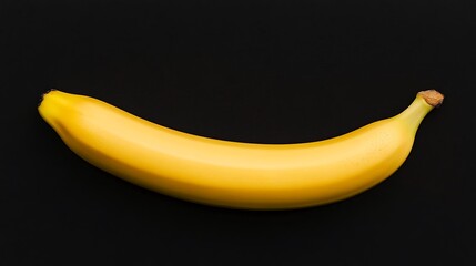 Single ripe banana on black background