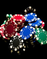 Various Stacks of Colorful Casino Chips Assembled on a Black Background in a Casino Setting