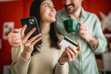 young couple use credit card and mobile phone for online shopping
