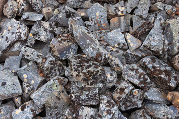 Closeup of grey sharp stones covered with lichens in tundra. Rybachy Peninsula, Murmansk region, Russia
