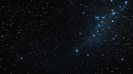 Fototapeta premium Night sky with dark clouds and scattered stars illuminated against a backdrop of deep blue