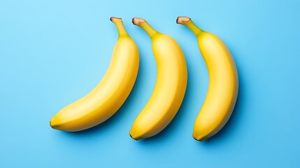 Three bananas arranged on a vibrant blue surface