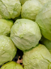 Top view, fresh cabbage with dew drops sold in the vegetable supper market. Vertical image.
