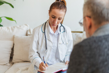 Female doctor examining older senior man in doctor office or at home. Old man patient and doctor...