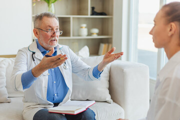 Senior man doctor examining young woman in doctor office or at home. Girl patient and doctor have...