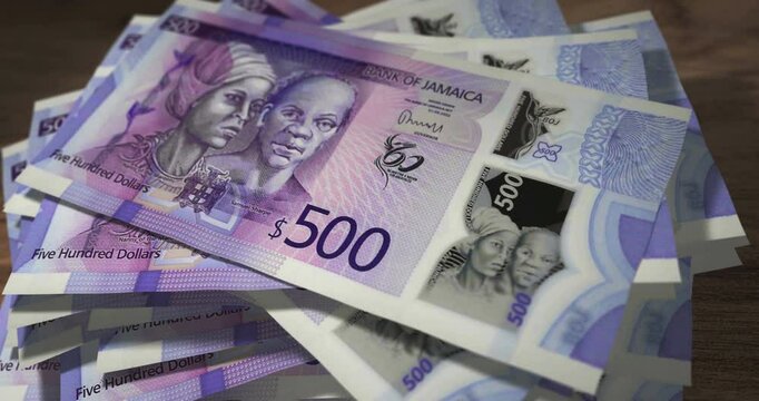 Jamaica dollar 500 JMD banknotes falling on the table. Jamaican currency paper notes count on stack. Timelapse of money counting. 3D concept.