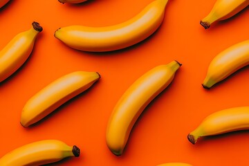 Yellow bananas arranged on an orange surface for healthy food and graphic design usage
