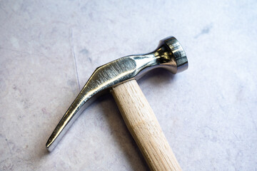 Shoemaker hammer with stainless steel and wooden grip,  Brussels city center, Belgium, FEB 22, 2025