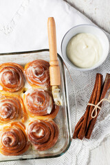 Cinnabons, cinnamon rolls topped with a cream of cream, cheese and sugar.