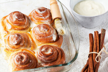 Cinnabons, cinnamon rolls topped with a cream of cream, cheese and sugar.