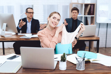 Young woman relaxes at work. She looks at the purchases.
