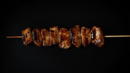 Sleek teriyaki chicken skewers present a modern culinary aesthetic against a black stone backdrop, highlighting the delectable appeal of teriyaki chicken in a vibrant and minimalist style.