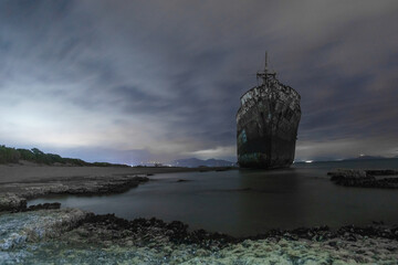 Abandoned stranded dimitrios shipwreck at the beach of Valtaki during night time, Peloponnese,...