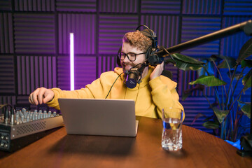 Live streaming with smiling millennial man as radio presenter with microphone, talk show or...