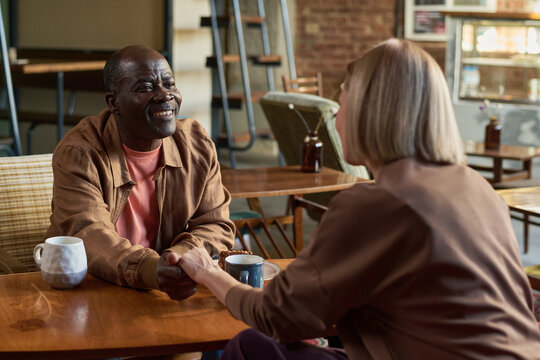 Smiling Elderly African American Man Enjoying Coffee Chat