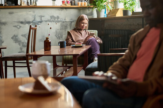 Enjoying Coffee at Cozy Cafe with Natural Ambiance