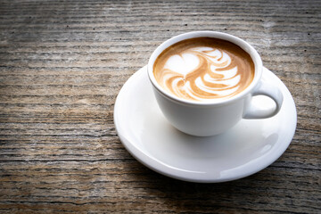 Coffee cup top view on wooden table background