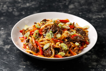 Stir fry udon noodles with beef and vegetable. asian style food