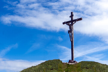 wooden cross on a background in the mountains