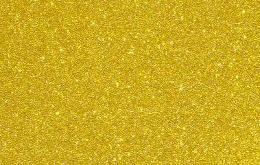 Golden yellow glitter bokeh background. Photo can be used for New Year, Christmas and all celebration concepts.