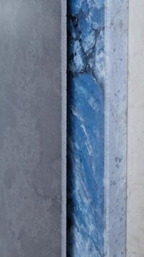 Colorful quartz and porcelain tile stone slab are standing in the factory warehouse. Kitchens and bathrooms countertop selection. Granite slabs are prepared for sale in store yard