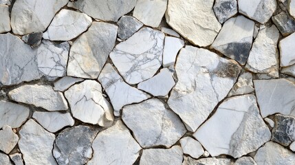 Obraz premium Irregularly shaped grey and white marble stones create a wall