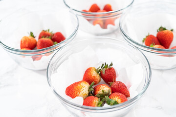 Fresh and Moldy Strawberries in a Glass Bowl on a White Napkin