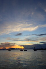 Fototapeta premium Seascape at sunshine. Lighthouse and sailings on the coast. Seaside town of Turgutreis and spectacular sunshine
