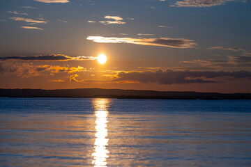 golden sunset over the water with reflection.