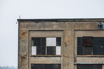 abandoned industrial building with weathered windows.