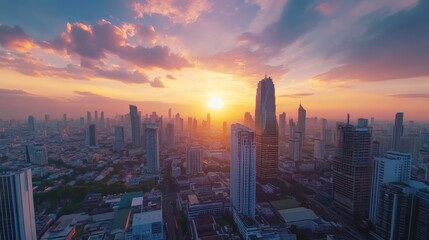 Fototapeta premium Time lapse of sunset in modern asian capital city as Bangkok. Drone camera fly above futuristic