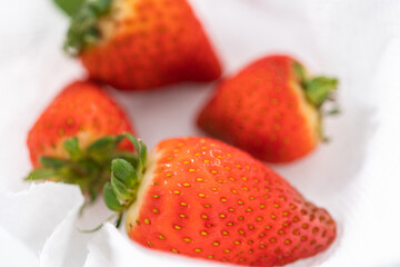 Fresh and Moldy Strawberries in a Glass Bowl on a White Napkin