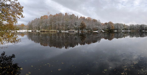 river bank, picturesque autumn panorama, yellow and white forest reflected in the river, wonderful...