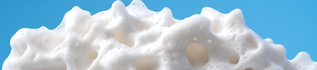 Obraz premium White Foam Texture Against Light Blue Background