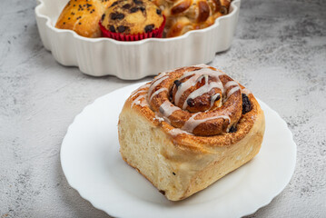 Delicious Glazed Cinnamon Roll on a White Plate